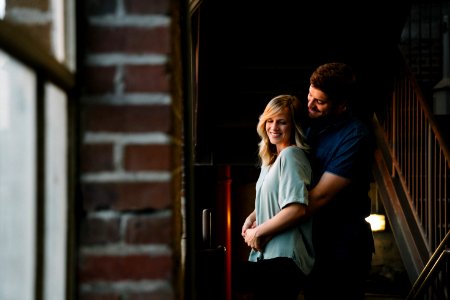 man hugging woman from behind near stair photo