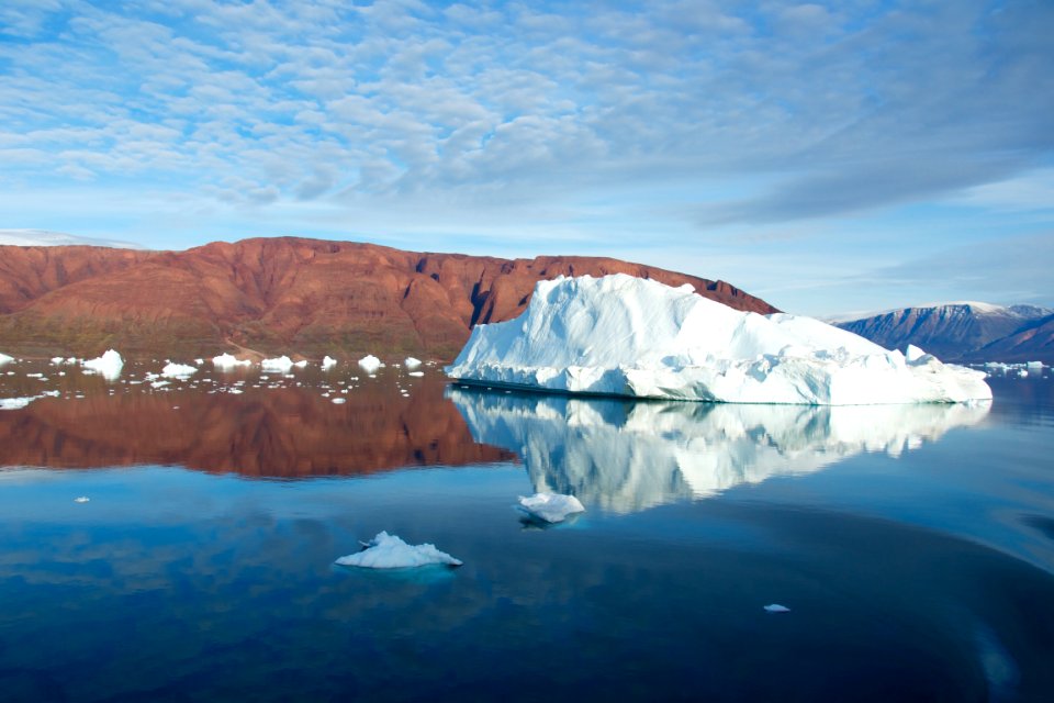 white ice formation on body of water under cloudy sky