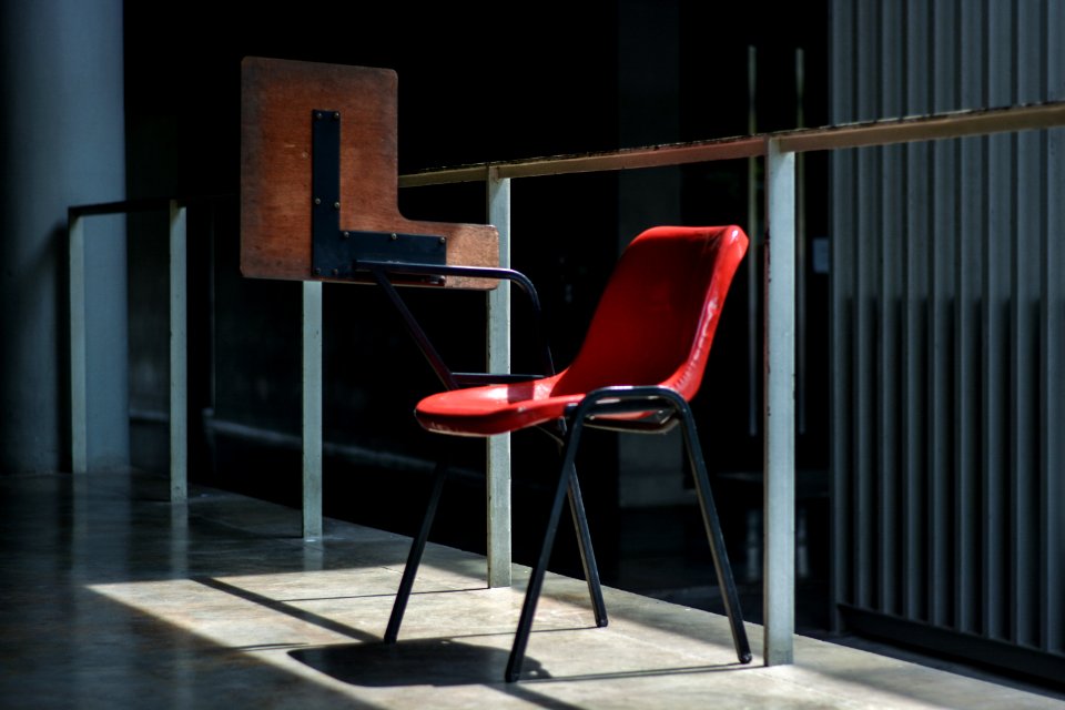 gray and red chair near the glass wall