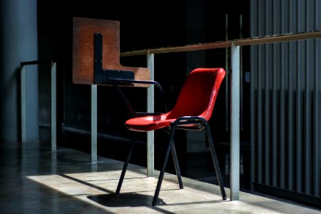 gray and red chair near the glass wall photo