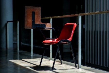 gray and red chair near the glass wall