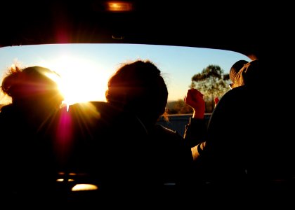 silhouette of three person inside car photo