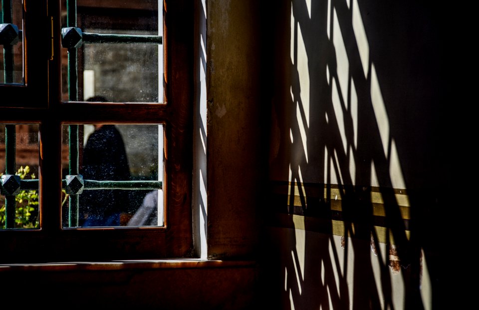 person behind window frame