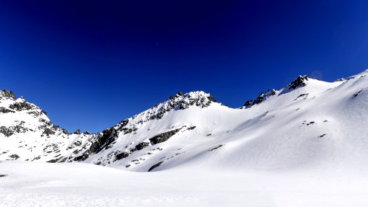 mountain covered with snow under blue sky photo