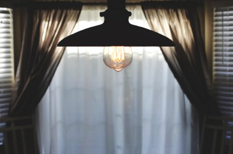 black pendant lamp in room with curtain photo
