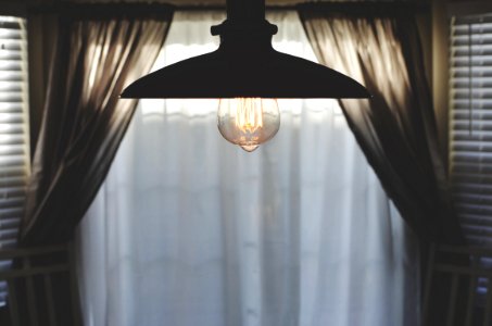 black pendant lamp in room with curtain