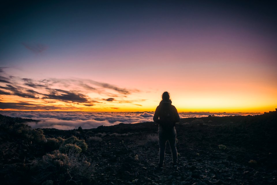 man standing on top of mountain photo