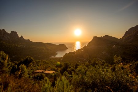 green mountain near body of water during golden hour photo