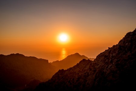 landscape photo of brown mountains near body of water photo