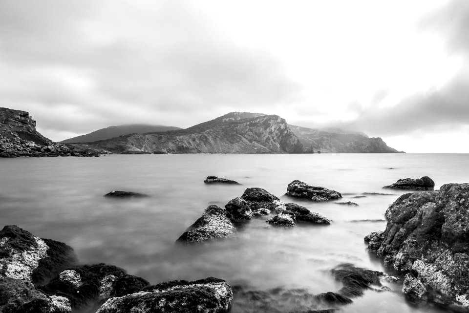 gray and black mountain near of body water