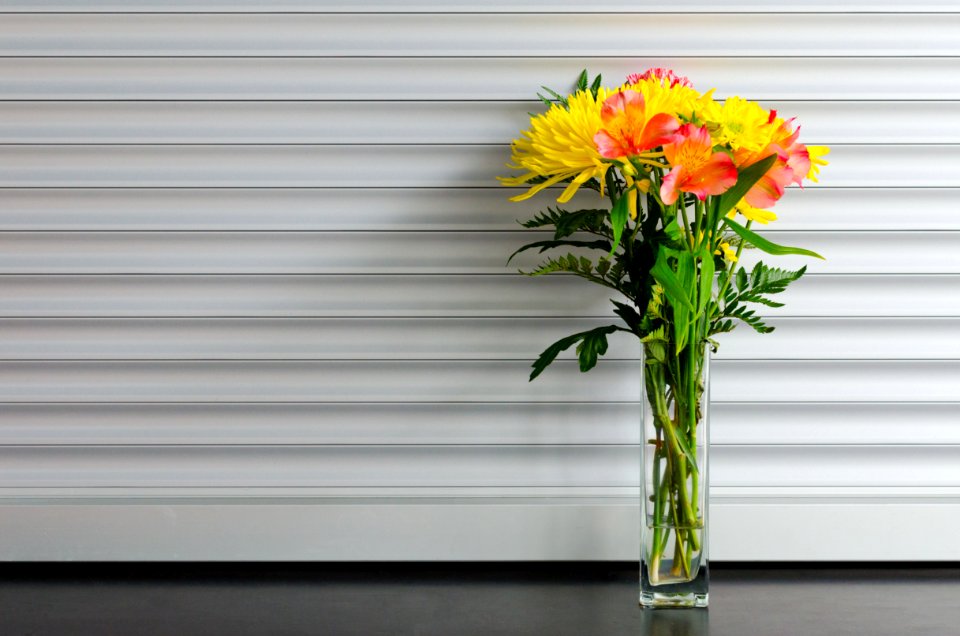 yellow and red petaled flower in clear glass vase