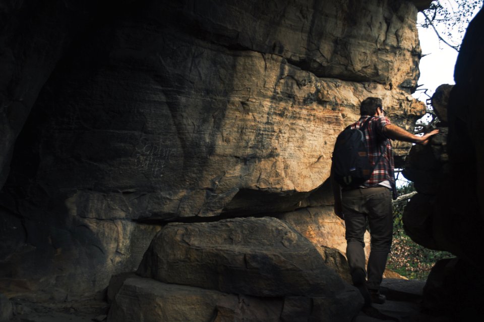 man with backpack at the cave photo