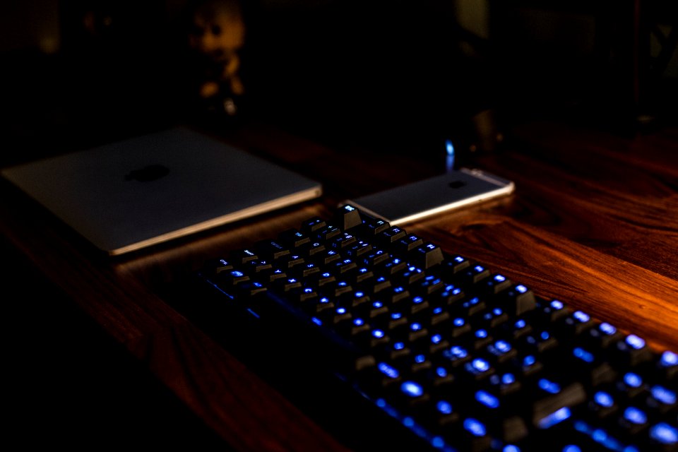 black computer keyboard on brown desk