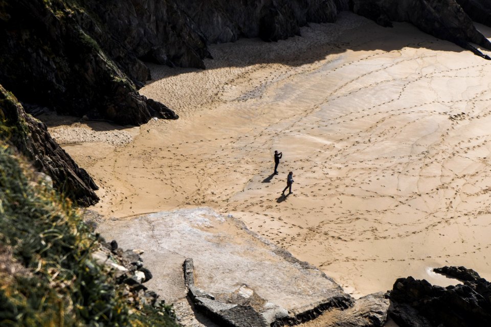 two people walking on desert