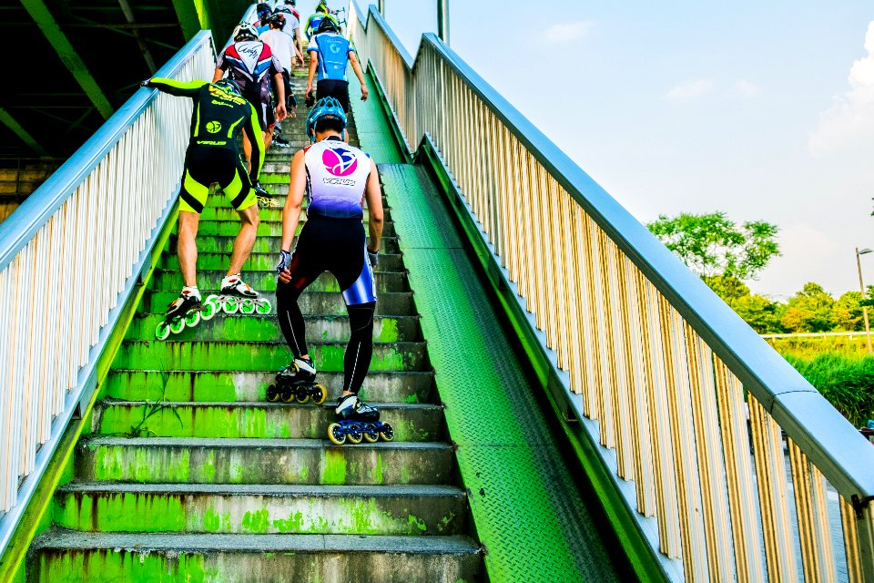 people wearing inline skates going upstairs