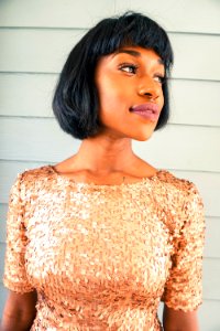 woman standing beside white painted wall photo