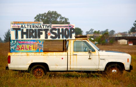 white single-cab truck with signage photo