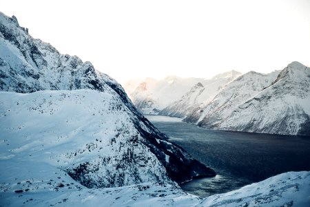 landscape photography of snow-coated mountains near body of water during daytime photo