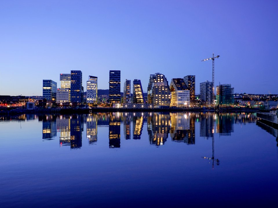 cityscape by water during golden hour photo