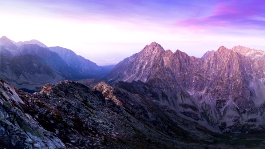 landscape photography of mountain ranges under purple and pink skies photo