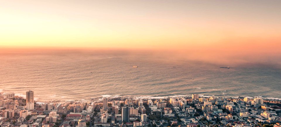 aerial photography of concrete buildings near beach during daytime photo