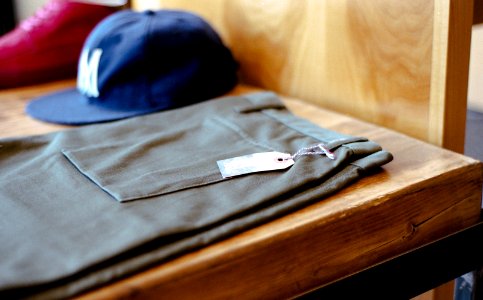 Men's hat and pants on a shelf.