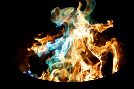 orange and blue flame on pile of wood