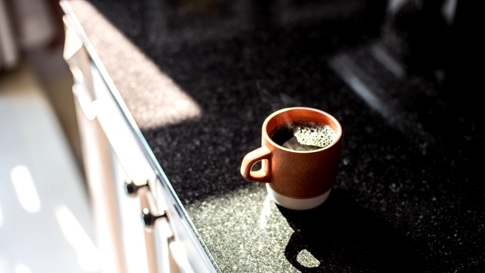 brown and white ceramic mug on table photo