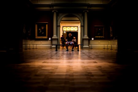 man sitting on bench on middle of house interior