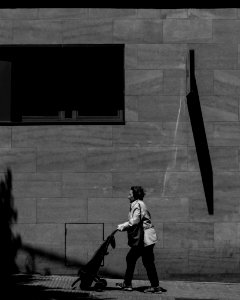 grayscale woman walking with stroller