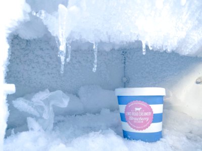 strawberry ice cream bottle inside container covered in ice photo