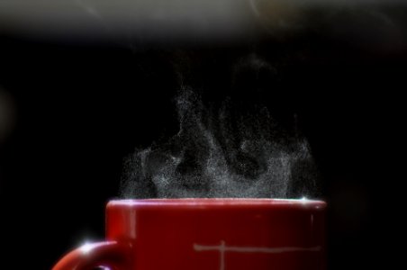 smoke coming out from mug filled with beverage photo