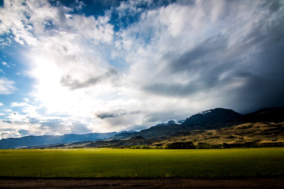 grass field under cloudy sky during daytime