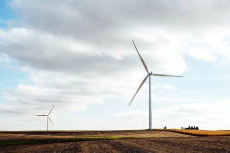 two white windmills on brown field during daytime photo