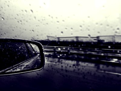 selective focus grayscale photography of side mirror and windshield with water dew photo