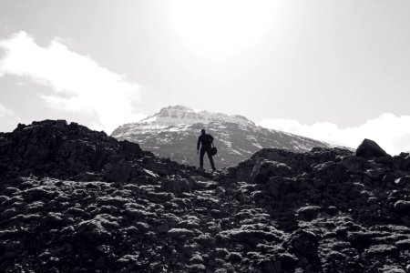 man on top of mountain during daytime photo