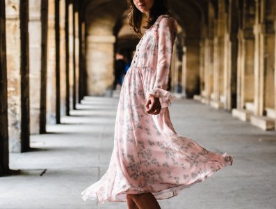 woman wearing pink long-sleeved dress standing inside building photo