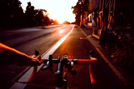 person riding on bicycle on road photo