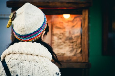 selective focus photo of person wearing beanie and sweater photo