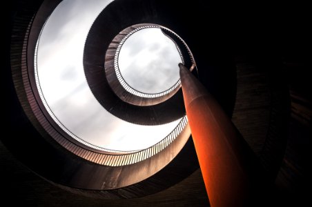 low angle photography of concrete spiral stairs photo