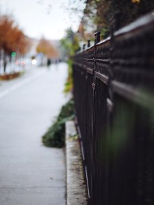 black metal fence near road during daytime photo