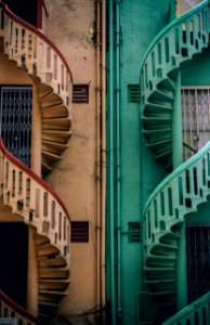 beige and green concrete spiral stairs beside building photo