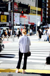 woman standing in pedestrian lane photo