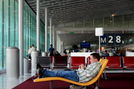 man sitting on airport waiting area photo