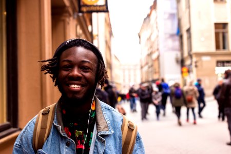 selective focus of man smiling near building photo