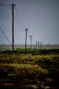 black utility post on green grass land photo