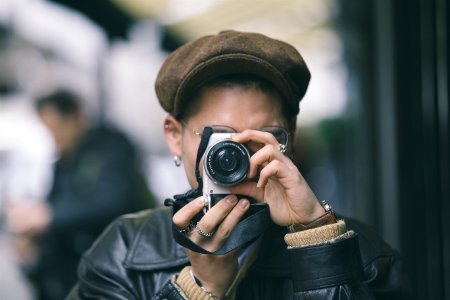 focus photography of person holding camera photo
