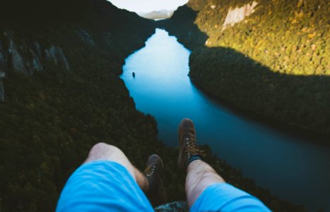 person laying on mountain edge photo