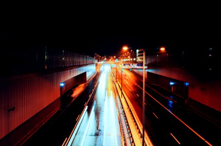 empty road with streaks of light during nighttime time lapse photography photo