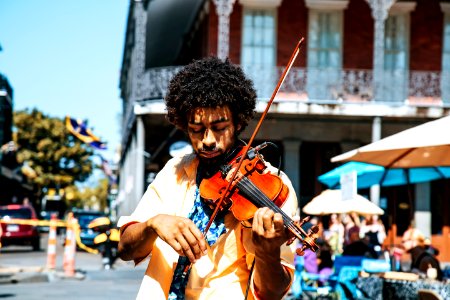 A man playing the violin or fiddle on the streets in New Orleans in the French Quarter photo